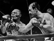American boxing champion Rocky Marciano (R) throws